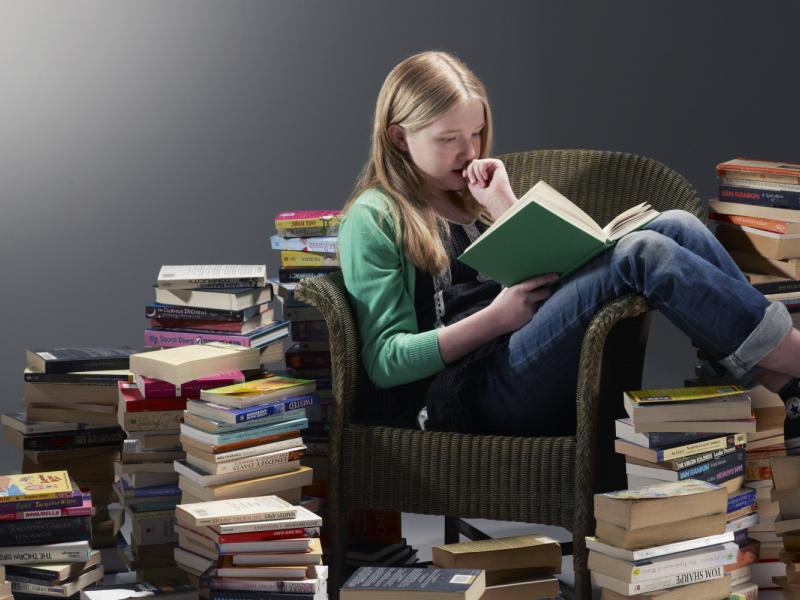 girl-reading-pile-of-books.jpg