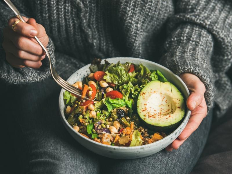 woman-eating-healthy-vegetarian-dinner-from-buddha-bowl-close-up.jpg